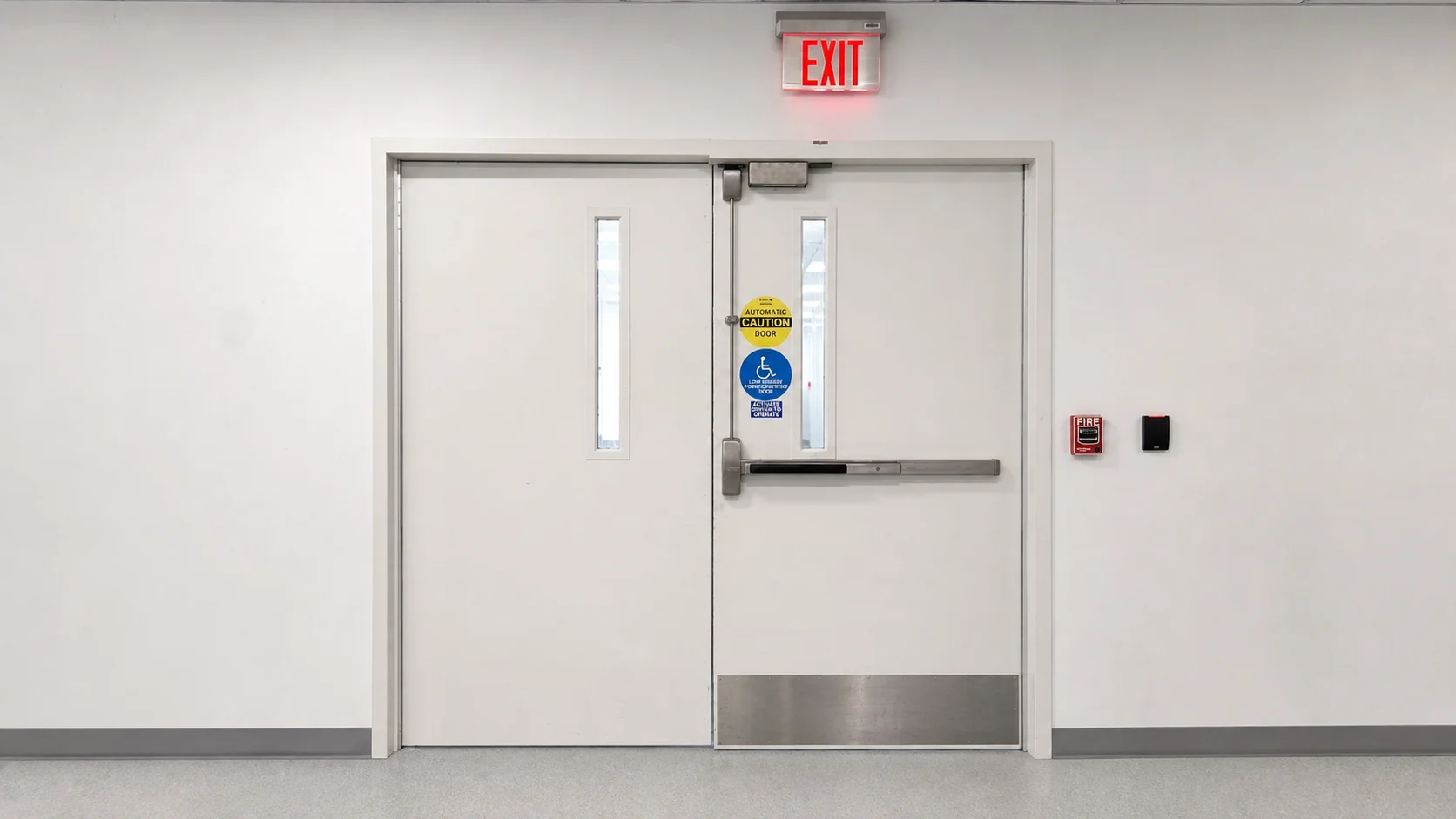 Healthcare fire-door assembly in a hospital corridor prepared for field inspection